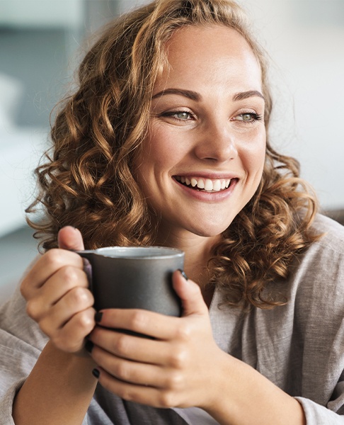 Woman smiling after veneers custom cosmetic dentistry treatment