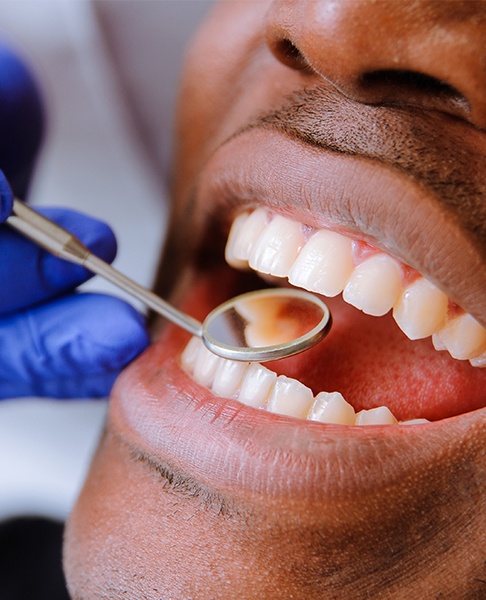 Dentist checking patient's metal free dental restoration