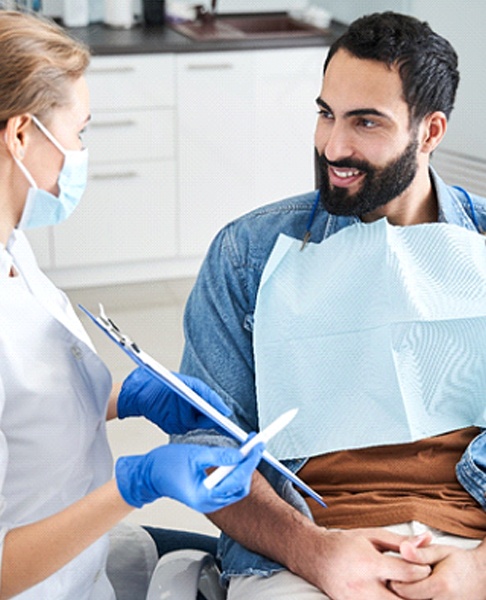 A male patient discusses the potential of a lower denture during a consultation
