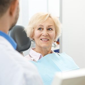 patient smiling while visiting dentist 