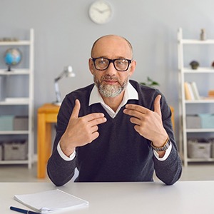 An older speaking with his partner across a table