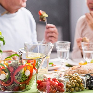 A close-up of healthy food being eaten by an elderly couple