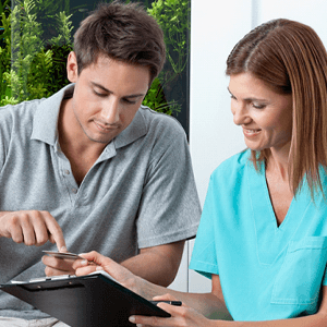 Man using card to pay for dental care