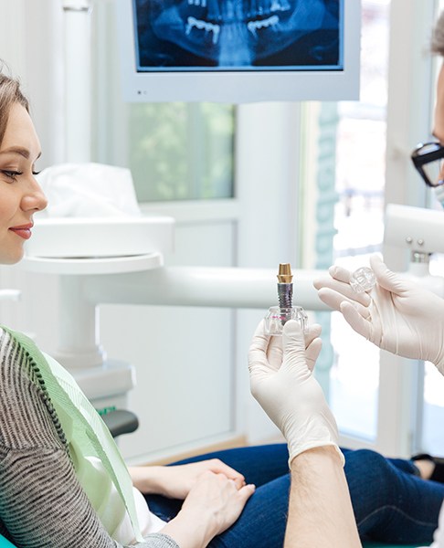 dentist explaining dental implants to patient