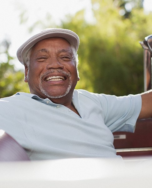 Man driving car with dental implants in Collegeville