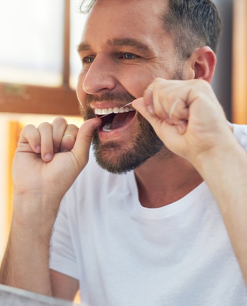 Man flossing his teeth