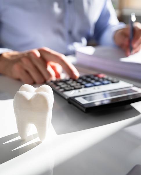 Person calculating dental insurance coverage