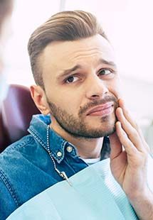 man holding his mouth from cavity pain in Trappe