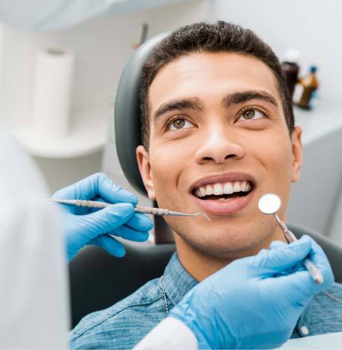 Man smiling getting a dental cleaning