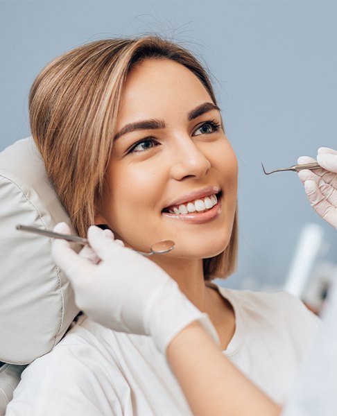 Woman smiling during preventive dentistry checkup and teeth cleaning visit