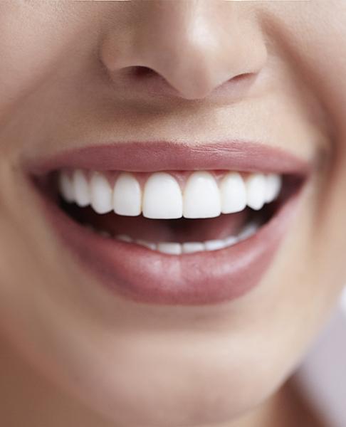 Closeup of healthy smile after gum disease treatment