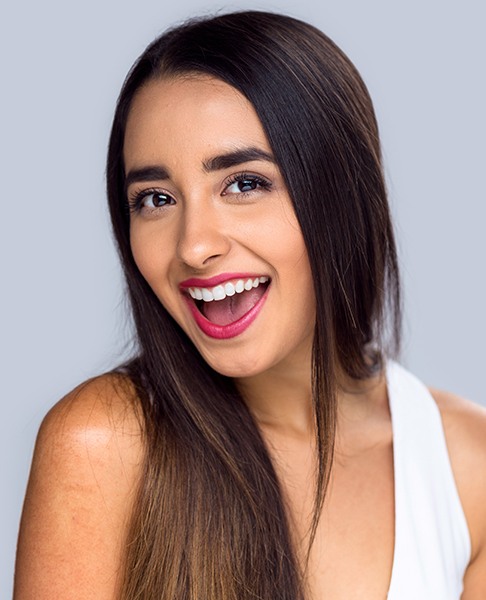 Woman showing off smile after tooth colored filling restoration