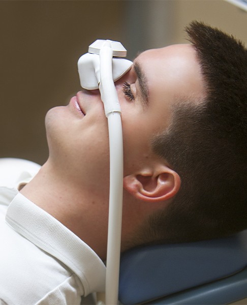 Relaxed patient with nitrous oxide dental sedation mask in place