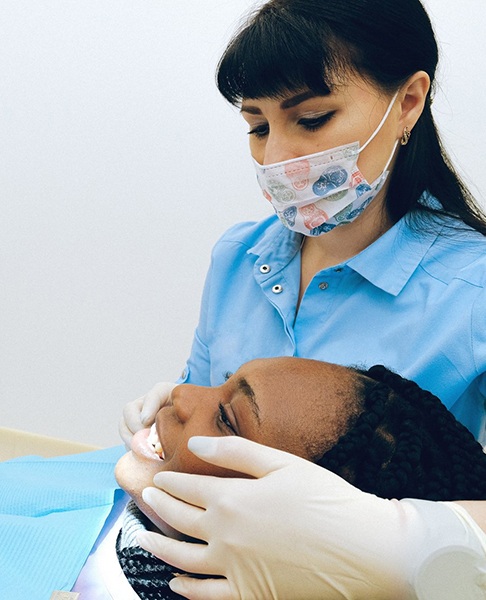 Woman at dental appointment looking in mirror